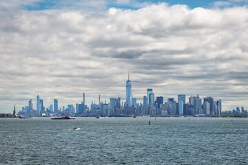 Wide panoramic view of the New York City skyline with skyscrapers surrounding Battery Park in Lower Manhattan.