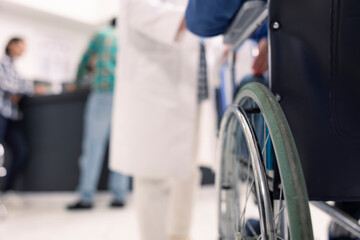 Patient with disability waits in hospital for medical consultation and recovery plan. Person in...