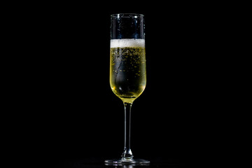 Festive pour of champagne with bubbles. Sparkling wine with bubbly champagne in luxury glass. Splash of champagne for party celebration.
