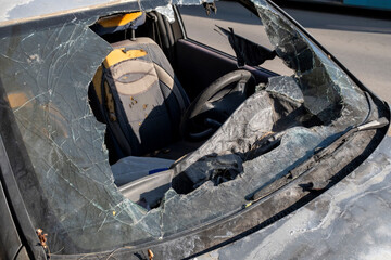 Destroyed car body after fire damage. Rusty burnt car wreck in industrial area. Burned abandoned...