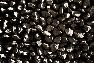 Stone fence with decorative design. Stone wall with geometric pattern. Exterior stone wall in minimalist style. Contemporary masonry with natural stone.