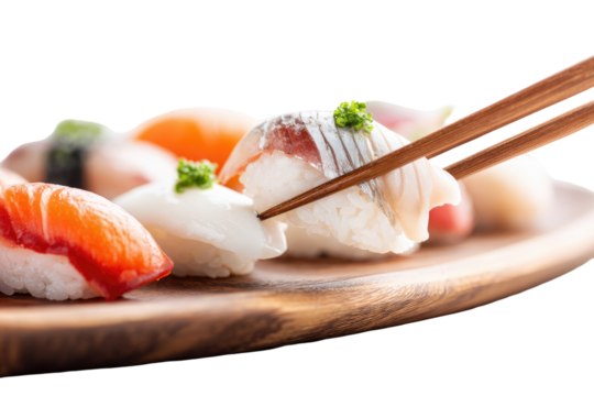 Close-up of sushi platter.  Chopsticks are lifting a piece of fish sushi.  Various types of sushi, including salmon, tuna, and possibly white fish. Wooden platter