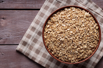 Whole Oats in Ceramic Bowl on Checkered Cloth Top View Copy Space