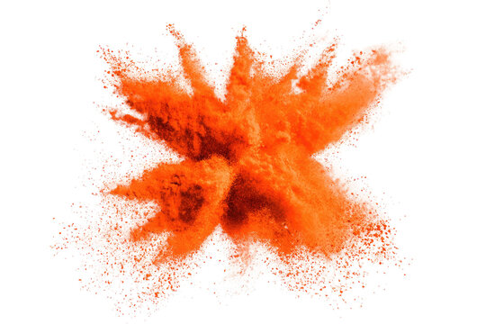 Explosive orange powder burst on black