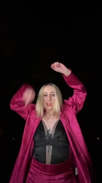 Young woman dancing waacking outdoors at night