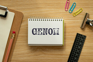 There is notebook with the word GENOM. It is as an eye-catching image.