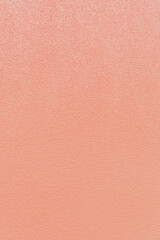 Textured abstract texture of a cement wall in soft pink color.