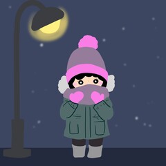 夜空に街灯の下でマフラーを巻く人