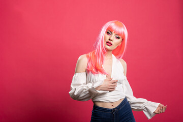 Confident caucasian woman in stylish outfit boldly modelling against isolated background. Stunning...