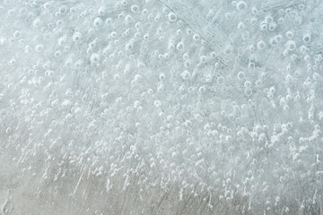 Fototapeta premium Frost forming intricate patterns on a window during winter season
