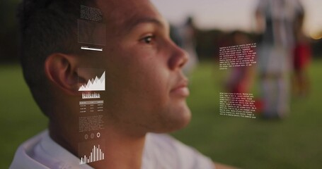 Male soccer player wearing white jersey analyzing data overlays on grass pitch at dusk, copy space