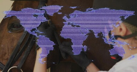 Handler in helmet adjusting bridle on brown horse in barn purple world map projection copy space © vectorfusionart