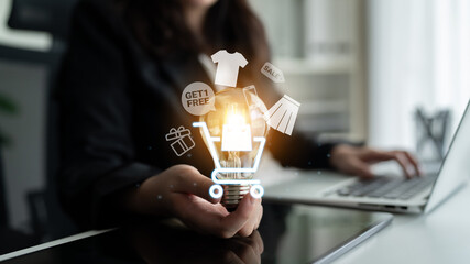 Glowing shopping cart with sale tags, clothing, and mobile items representing online retail...