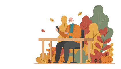 Senior man uses smartphone at outdoor table surrounded by autumn leaves