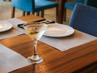 Classic Martini Cocktail with Olives Served at a Restaurant