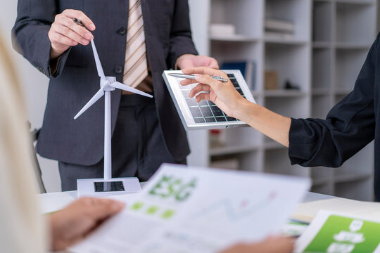 Business people discussing esg with renewable energy models