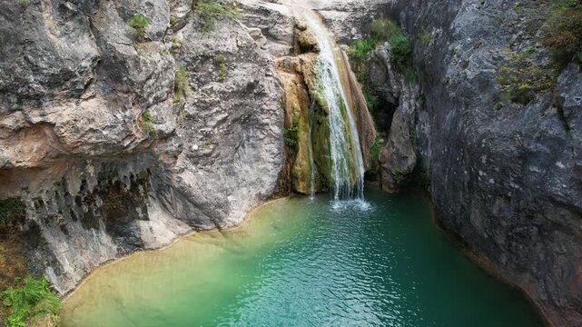 Tripod aerial shot of La Gorguina waterfall in Gorg Gorge (Barranc del Gorg) on summer day. La Febr&oacute;, Tarragona, Spain.