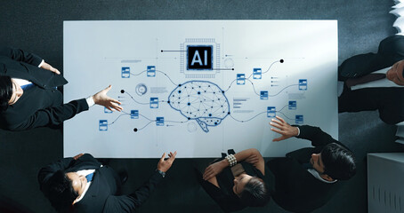 Business professionals collaborate in a meeting focused on artificial intelligence strategies,...