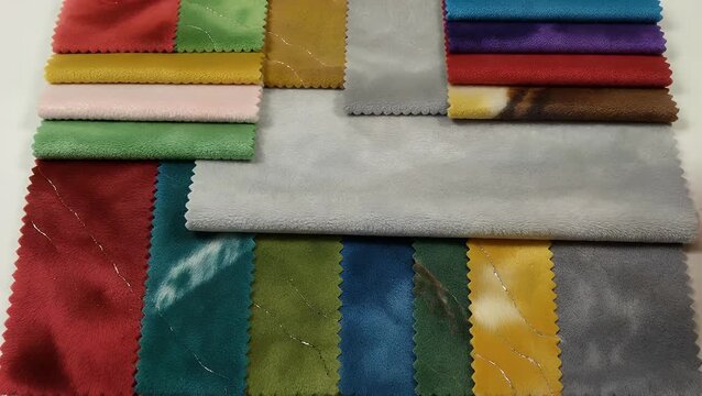 collection of vibrant colored specimens of plush fabric used for furniture covering examined at a short distance  showcasing a range of gray tone samples for renewing home