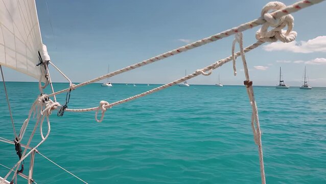 taut nautical rope line with the deep blue waters of a southern European sea visible behind