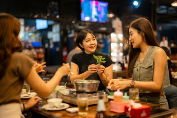 Young asian women friends enjoying hot pot dinner