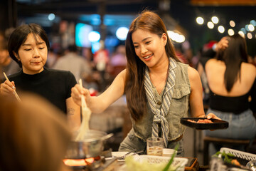 Asian women enjoying hot pot dinner with friends