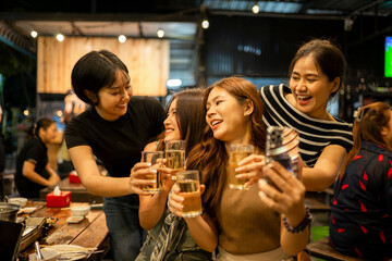 Asian women friends celebrating at night taking selfie