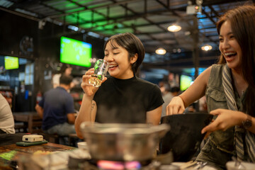 Happy women enjoying dinner and drinks at restaurant
