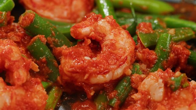 Tamarind red prawn curry cooking, shrimps in tomato ginger sauce, asian kitchen, Chinese restaurant.