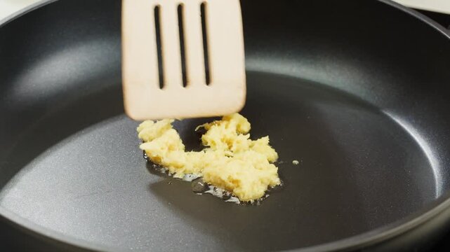 Peeled and Finely Chopped Ginger or garlic Root, Diced ginger on a wooden cutting board prepared for stew grill.