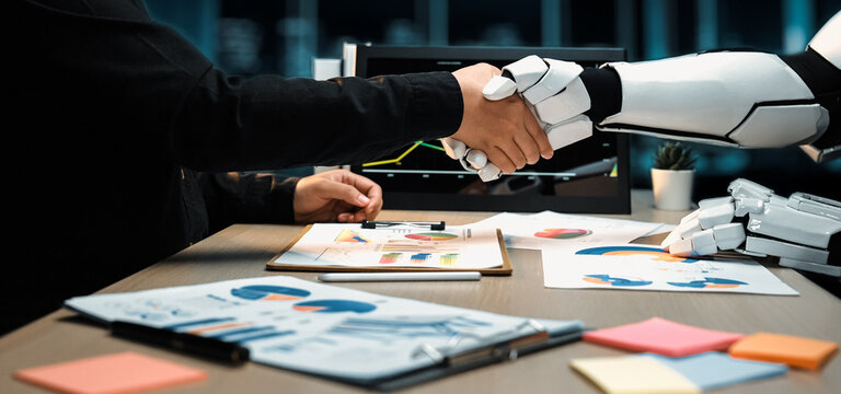 A human and robot shake hands in a sleek office, representing the collaboration between technology and business, with charts and graphs highlighting progress.Noogenesis