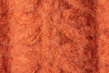 Knitted product made of brown wool as a background.