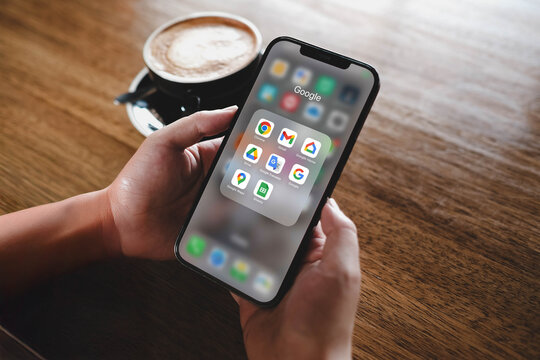 Bangkok, Thailand. November 4, 2025; A person holding an iPhone with a folder of Google Workspace apps, including Gmail, Drive, Docs, and Sheets for productivity.