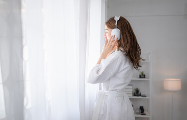 A young woman and a new morning with beautiful music in the morning sunlight