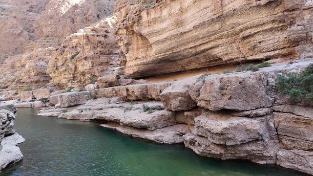Wadi Ash Shab is a dramatic canyon in Oman famous for its hiking trail leading to emerald pools, a hidden cave, and a stunning internal waterfall.
