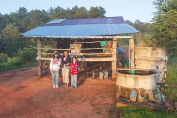Family Posing Near Water Well in Countryside