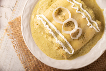 Green Enchiladas with creamy green sauce filled with shredded chicken meat and covered with melted cheese, in Mexico they are called Swiss Enchiladas. Very popular recipe in Mexican cuisine.