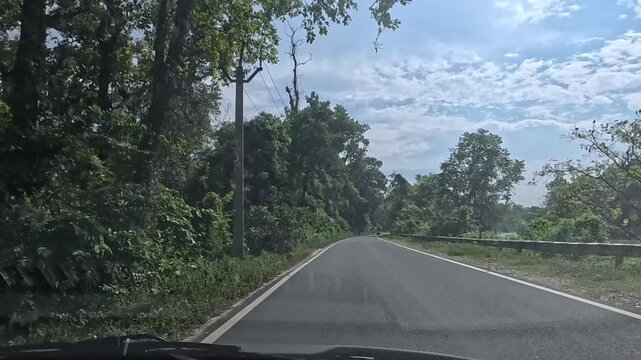 23.10.2025.Bagrakote West Bengal India  4k video clip of a road trip in a car as seen from driver point of view on a bright sunny day in India
