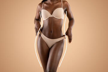 Black model presents her fit and youthful figure in beige underwear, highlighted by curvy white lines. The neutral studio background offers a clean and appealing aesthetic.