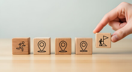 Strategic planning blocks: wooden cubes with growth and location icons and a pointing hand &mdash; business strategy and goal setting concept

