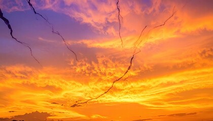 Vibrant Orange and Purple Sunset Sky with Wispy Clouds and Cracks.