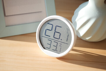 Indoor temperature and humidity display on wooden table