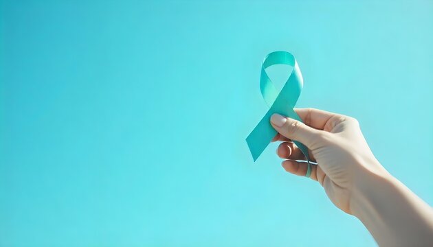 A person showcases a turquoise ribbon, embodying hope and awareness for cervical cancer during Women's Health Month