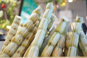 Sugarcane stalks arranged in a vibrant market setting