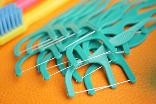 Dental hygiene tools arranged on a colorful surface