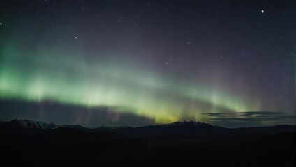 Aurora Borealis Shimmers Above Dark Landscape - A Celestial Dance of Light.