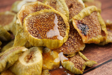  Dried figs arranged on a wooden surface with honey drizzle