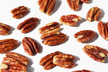 Delicious salted pecan nuts scattered.