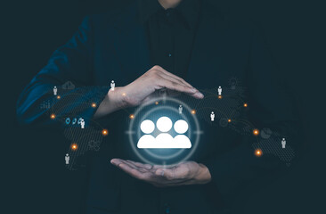 Businessman protecting digital people network icon with glowing connections around the world,...