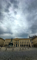 Reims, Marne, Grand-Est, France, August, 28th, 2025, Champagne Area, A magnificent and imposing building stands proudly in a historic square, surrounded by gloomy, overcast skies